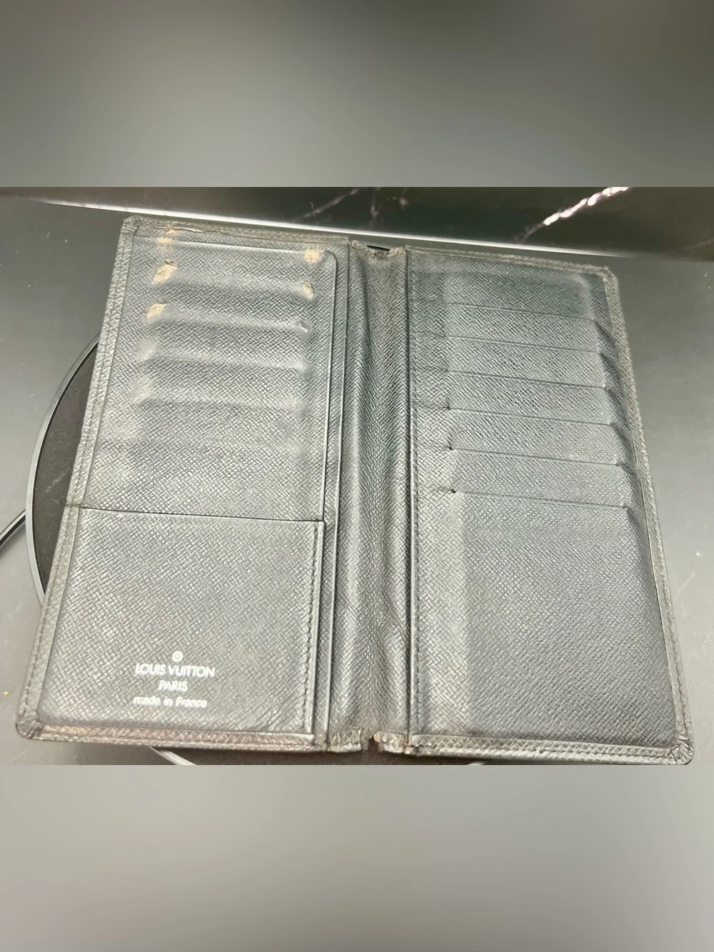 Louis Vuitton Taiga leather Brazza wallet in black. Fair condition. Unisex